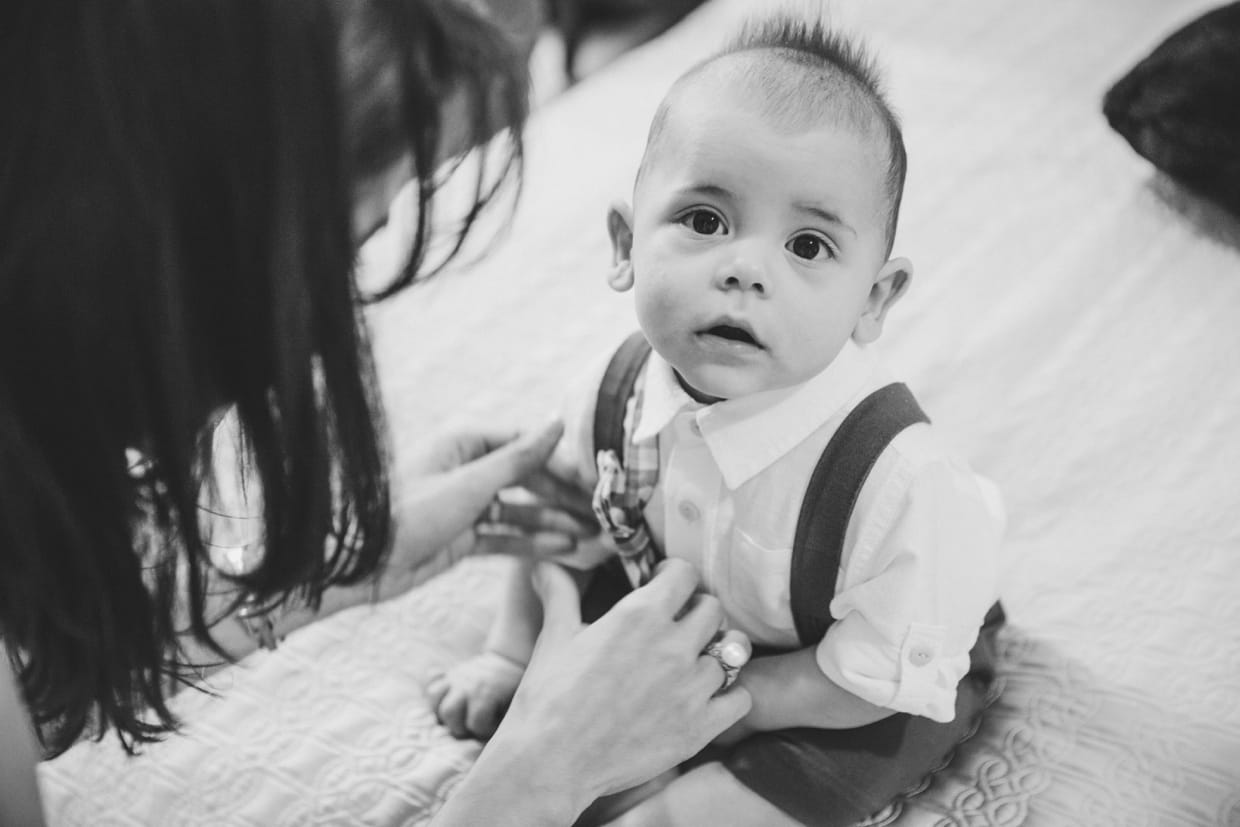 A cute portrait of a baby boy getting dressed for his in home family session in Boston.