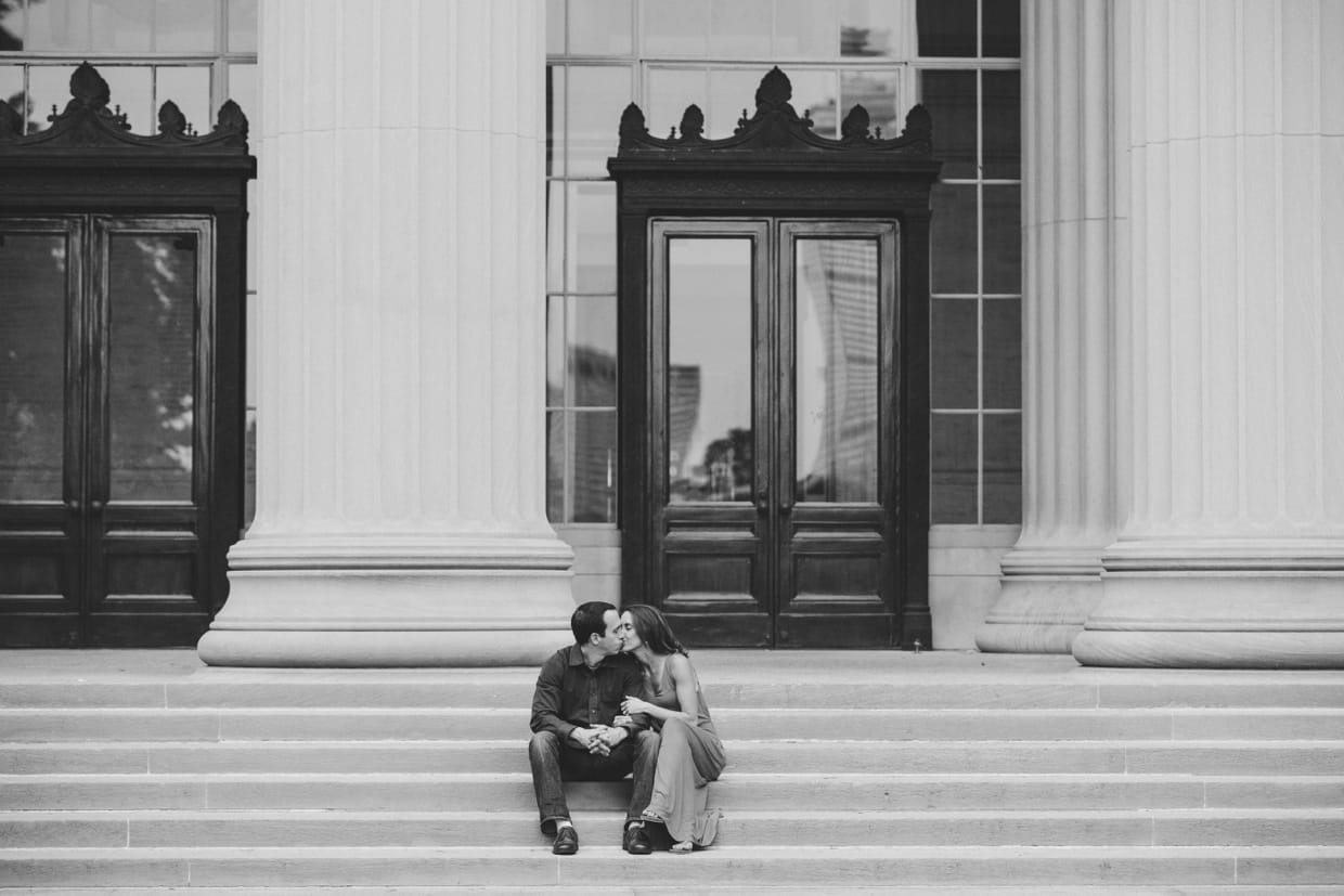 A natural photograph of a couple kissing on the steps of the Massachusetts Institute of Technology during their couple session in Cambridge
