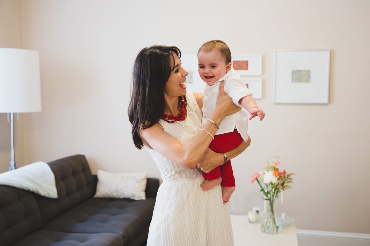 A natural and fun portrait of a mother holding her baby boy in their Boston home. 