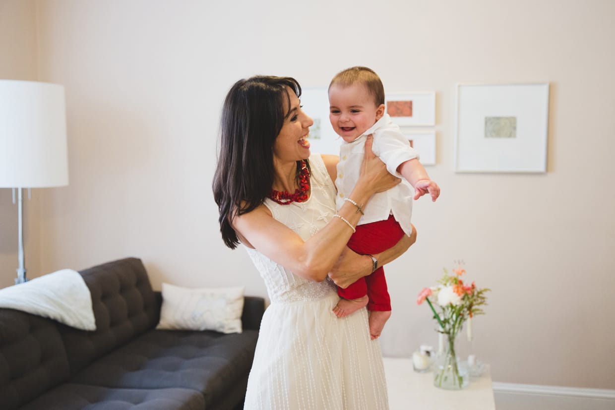 A mother holds her baby boy during their mini family photo session in Boston