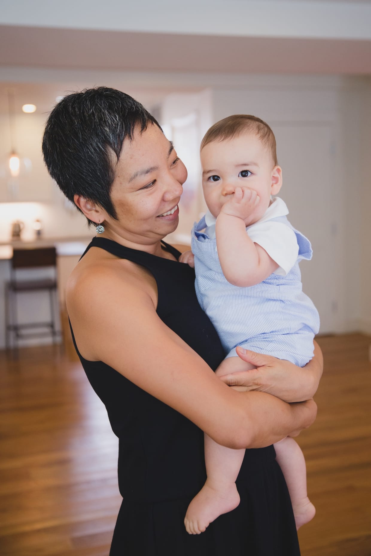 A sweet portrait of a mother holding her baby boy during their in home family photo session in Jamaica Plain