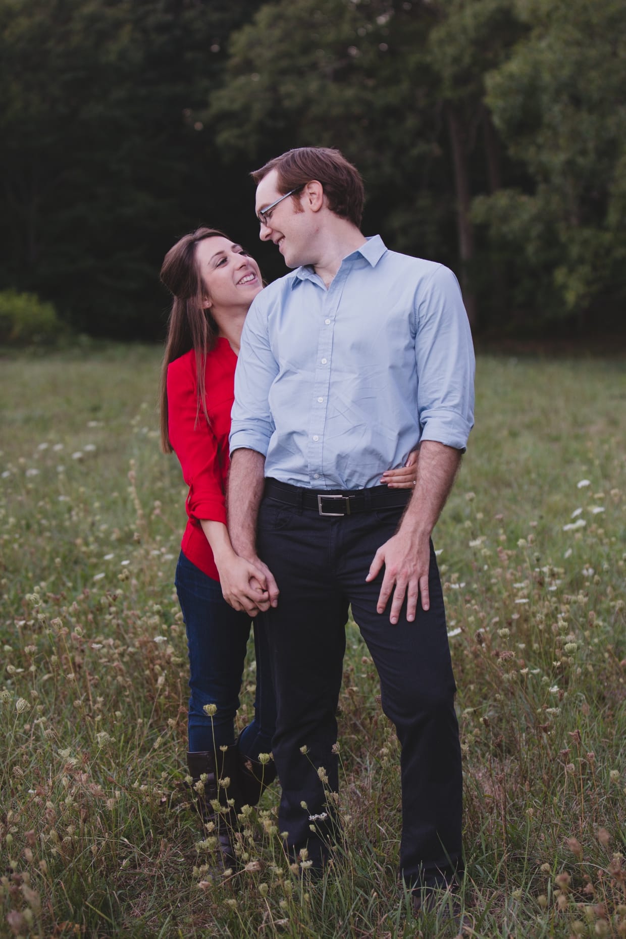 A super cute and sweet photograph of a couple in a field during their Arnold Arboretum Engagement session in Boston