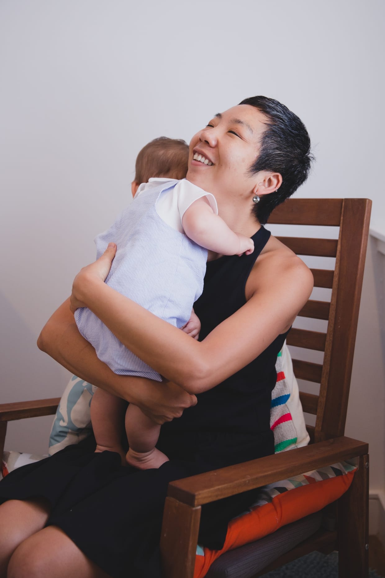 A sweet photograph of a mother holding her baby boy during their in home family photo session in Jamaica Plain
