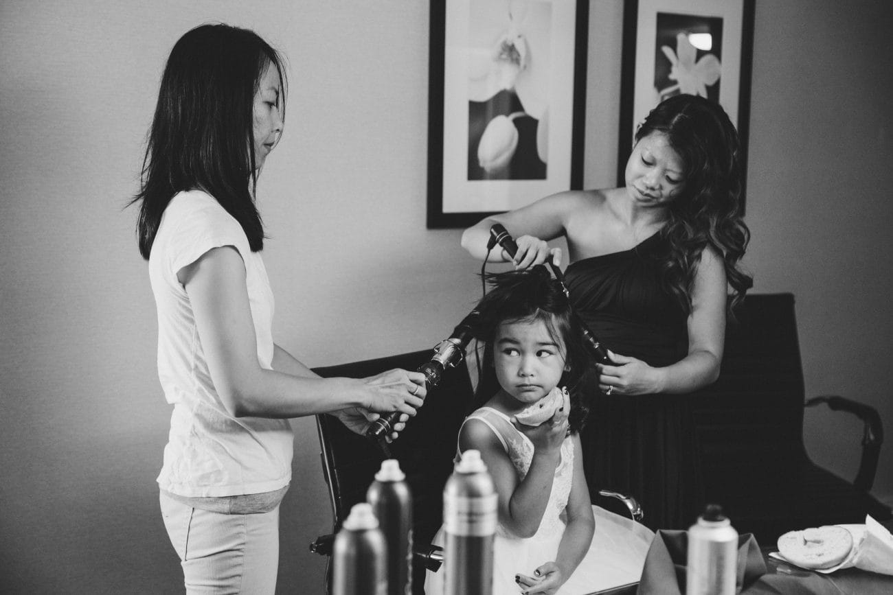 A documentary style photograph of a flower girl getting her done before a vietnamese tea ceremony in Boston