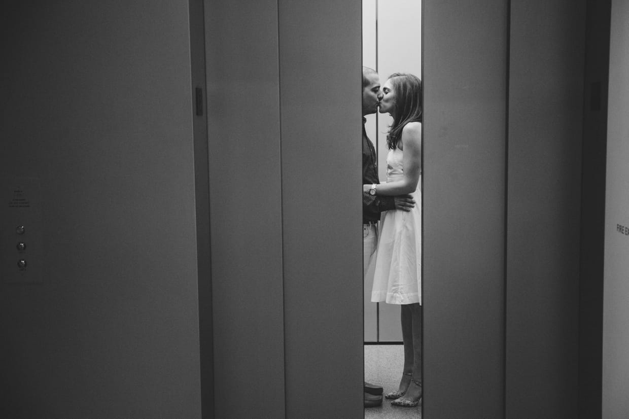A creative photograph of a couple kissing in the elevator during their engagement session the Museum of Fine Arts in Boston