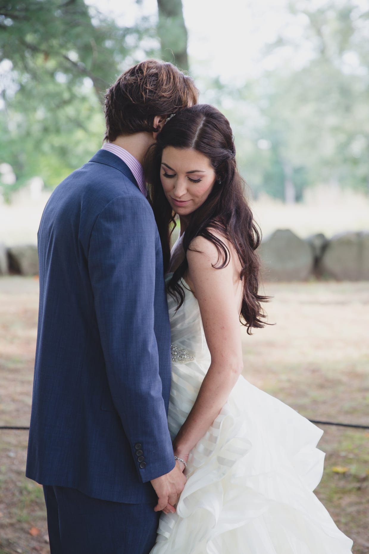 A sweet and romantic portrait of a bride and groom during the first look before their backyard wedding