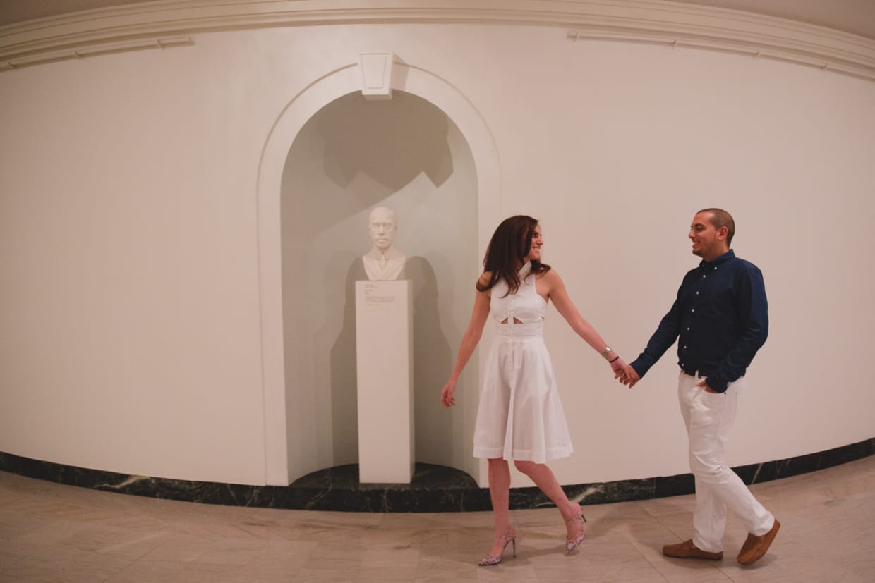 A sweet photograph of a couple walking through the Museum of Fine Arts during their engagement session in Boston, Massachusetts