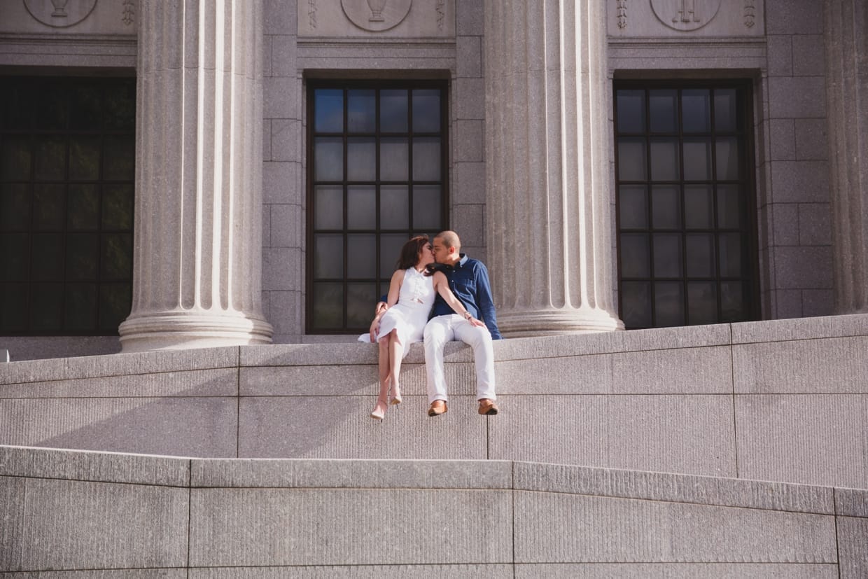 A cool photograph of a couple kissing at the Museum of Fine Arts during their engagement session in Boston, Massachusetts