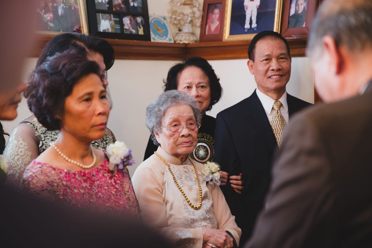 A documentary style photograph of a family during a vietnamese tea ceremony in Boston