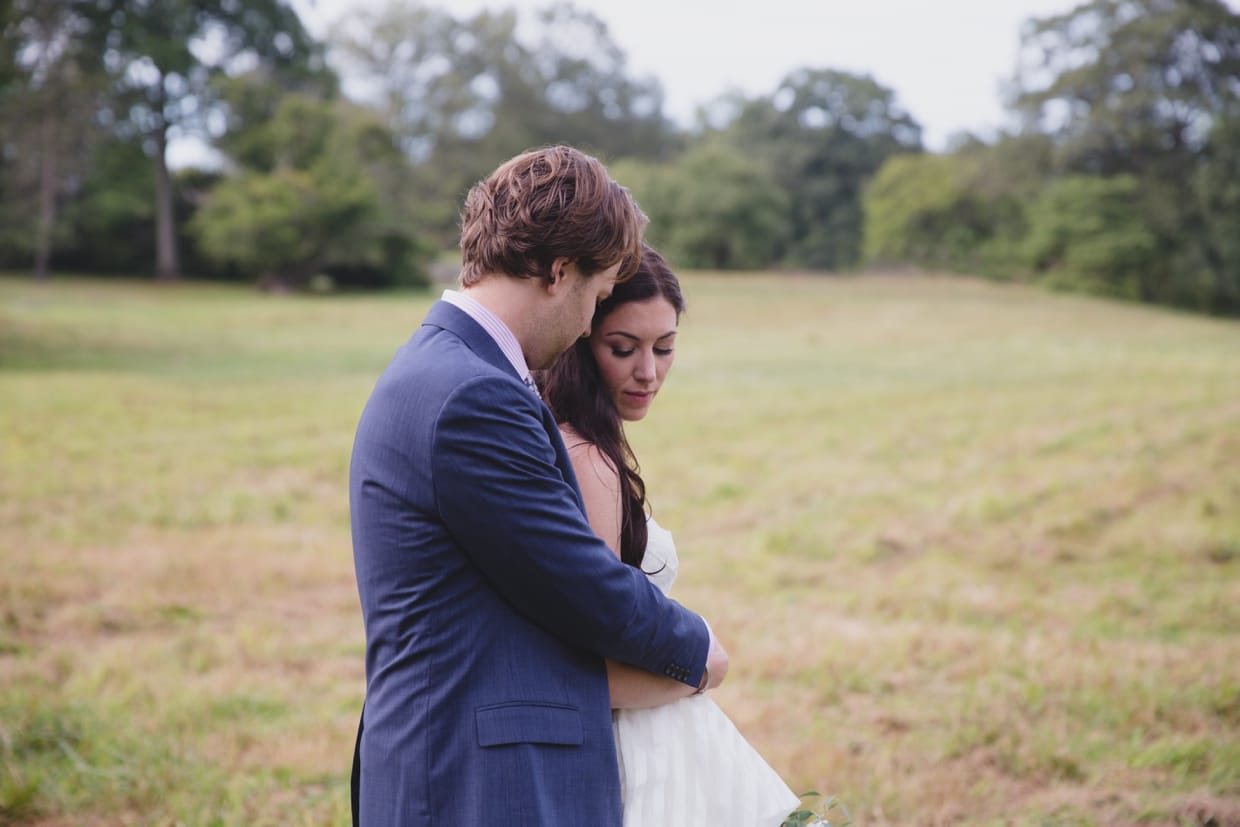 A sweet and romantic wedding portrait during a first look at the Minute Man Park in Massachusetts