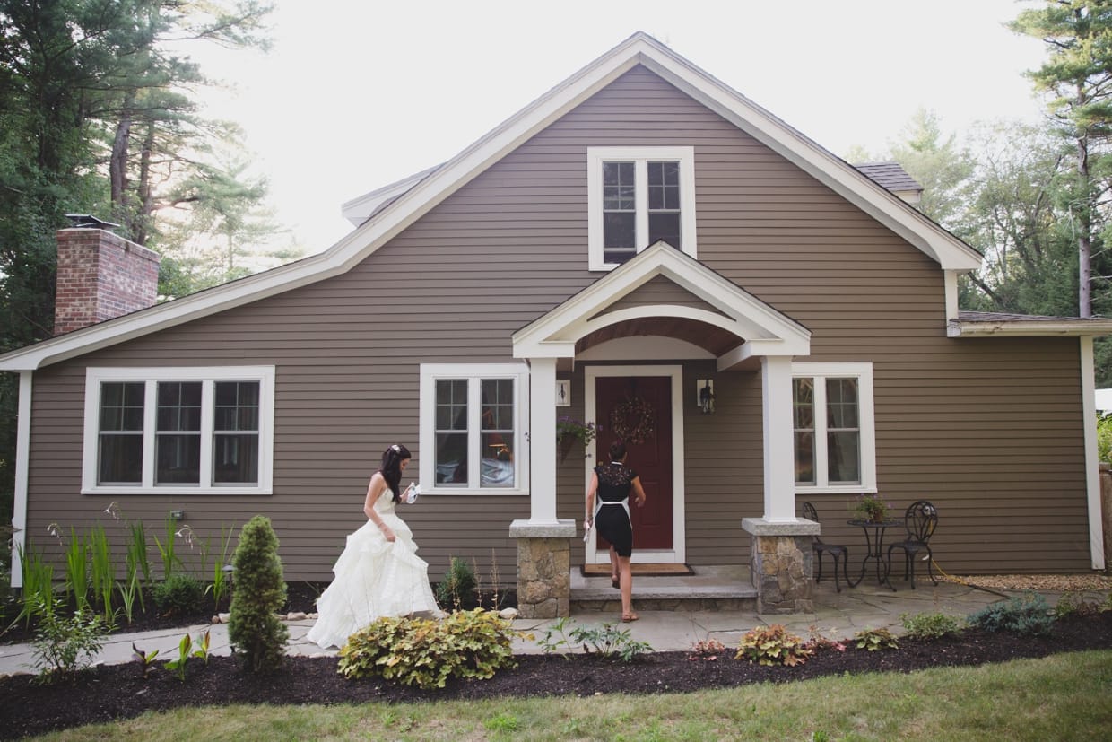 A bride walks into her house just before her backyard wedding ceremony begins.