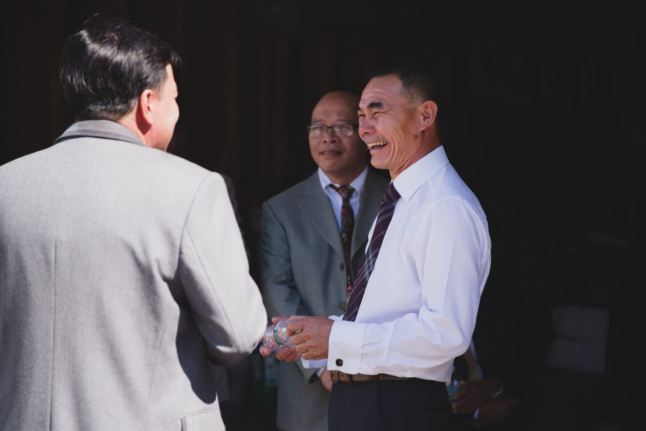 A candid photograph of guest talking in laughing after a vietnamese tea ceremony in Boston