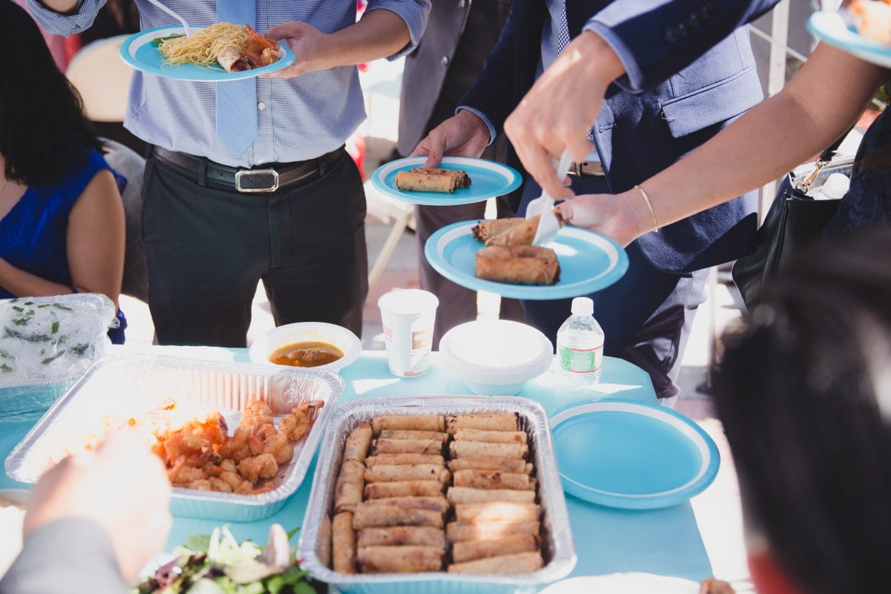A documentary style photograph of guest serving themselves traditional food after a vietnamese tea ceremony in Boston