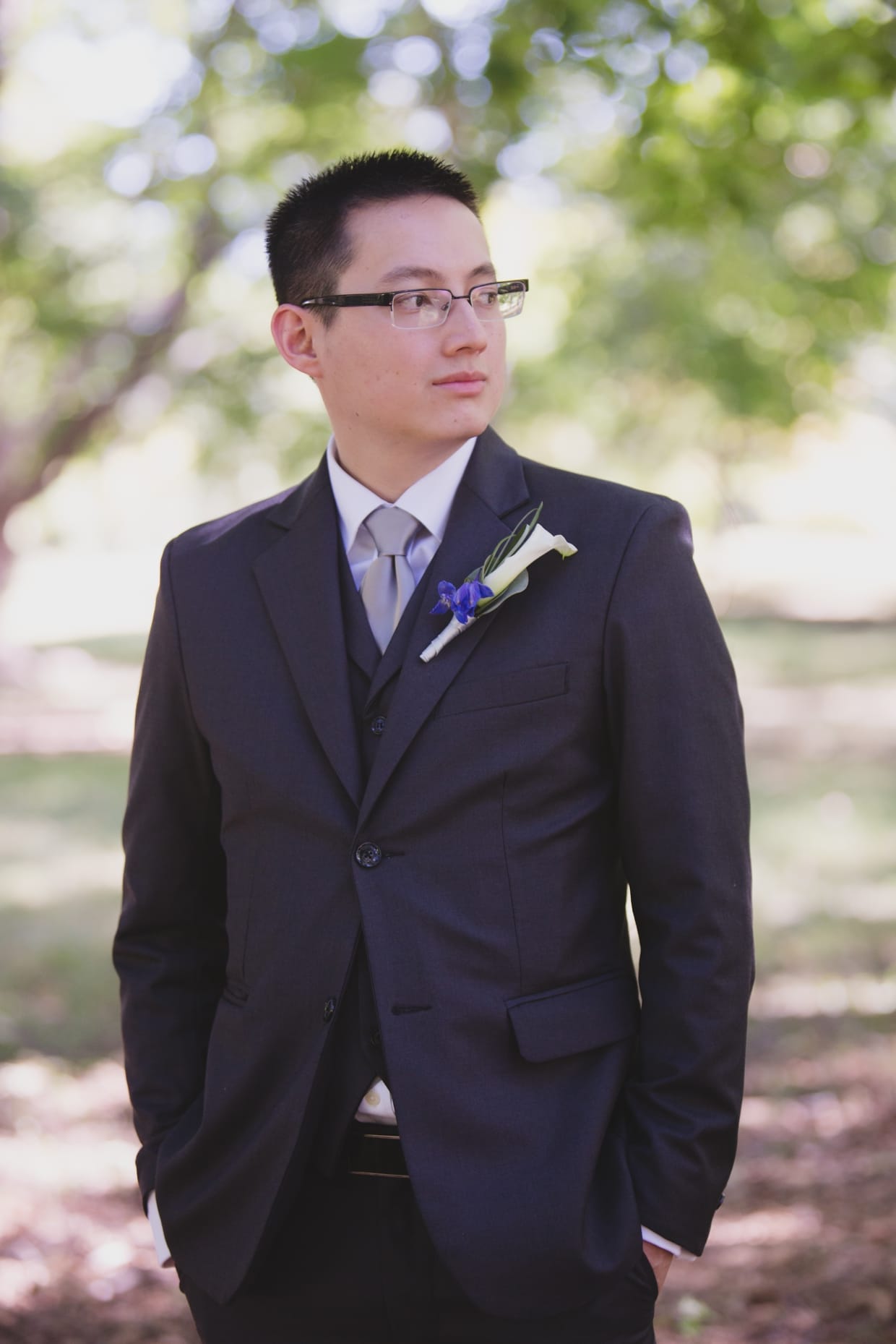 A groom waits for his bride during their first look at the Arnold Arboretum in Boston, Massachusetts