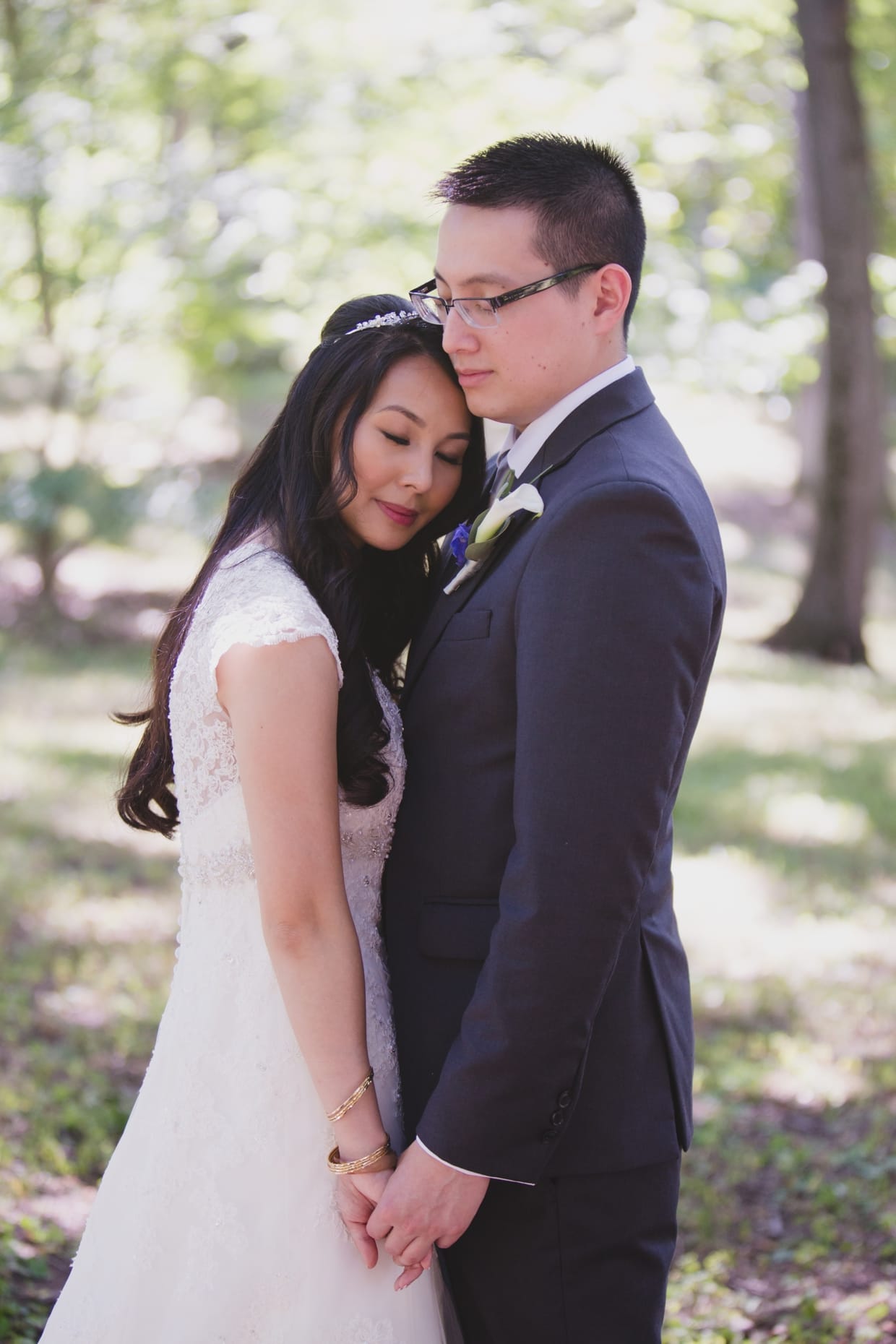 A bride and groom share a sweet moment during their first look at the Arnold Arboretum in Boston, Massachusetts