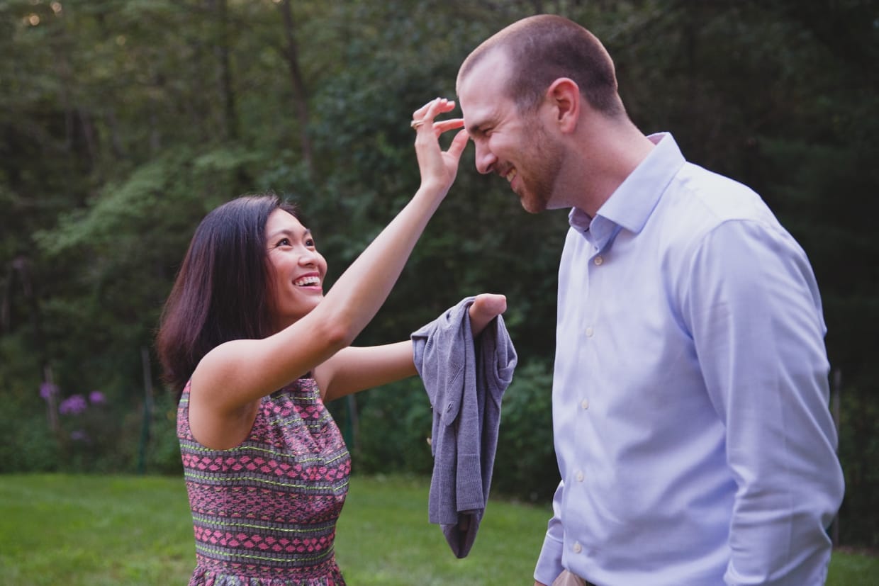 A candid photograph of guests interacting during a backyard wedding in Massachusetts