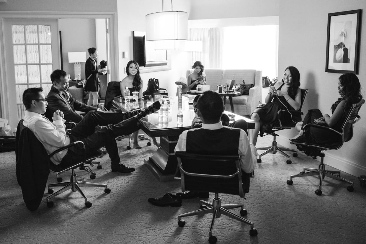 A documentary style photograph of the wedding party hanging out in the hotel room before the wedding at the Boston Marriott Hotel