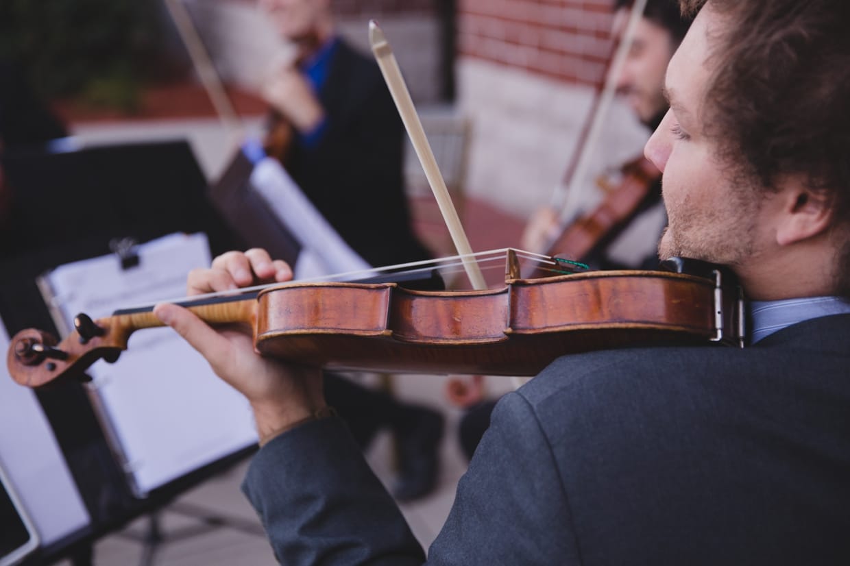 An artistic photograph of violinist during a wedding ceremony at the Boston Marriott Hotel