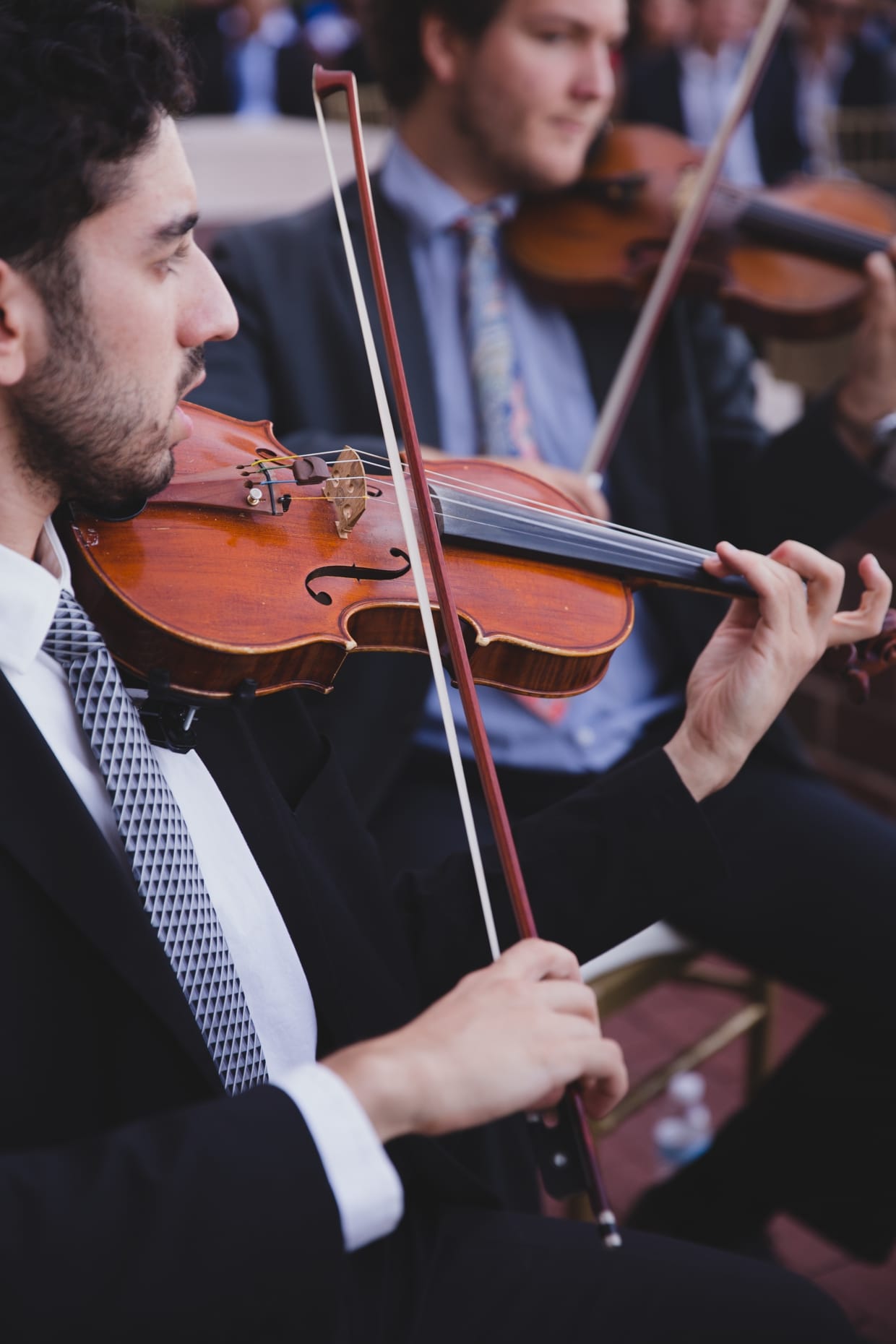 An artistic photograph of a violinist during a wedding ceremony at the Boston Marriott Hotel