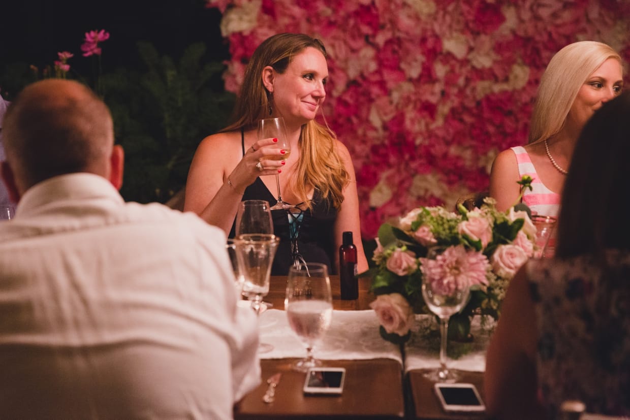 A candid photograph of a guest making a toast at a backyard wedding in Massachusetts
