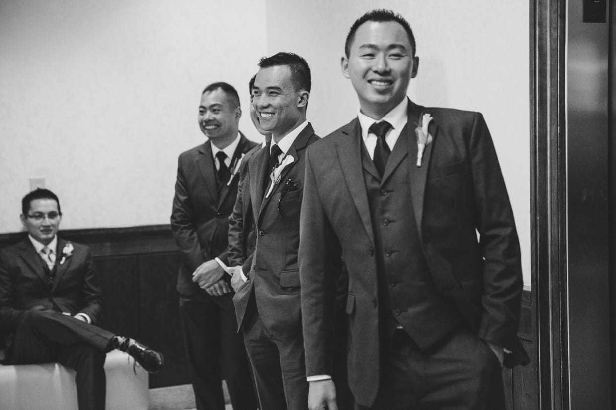 A candid photograph of the groom and groomsmen moments before the wedding ceremony at the Boston Marriott Hotel