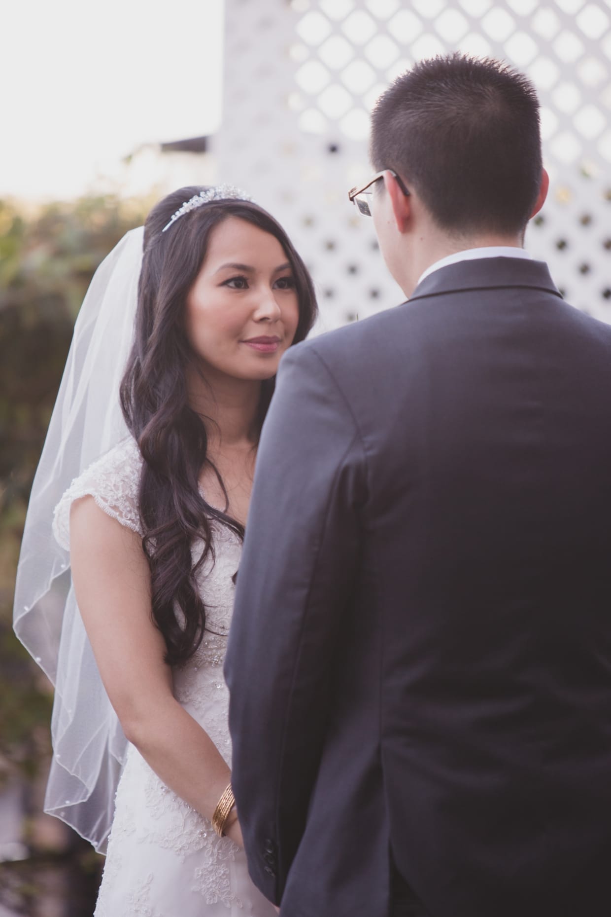 A beautiful photograph of a bride looking at the groom during their wedding ceremony at the Boston Marriott Hotel