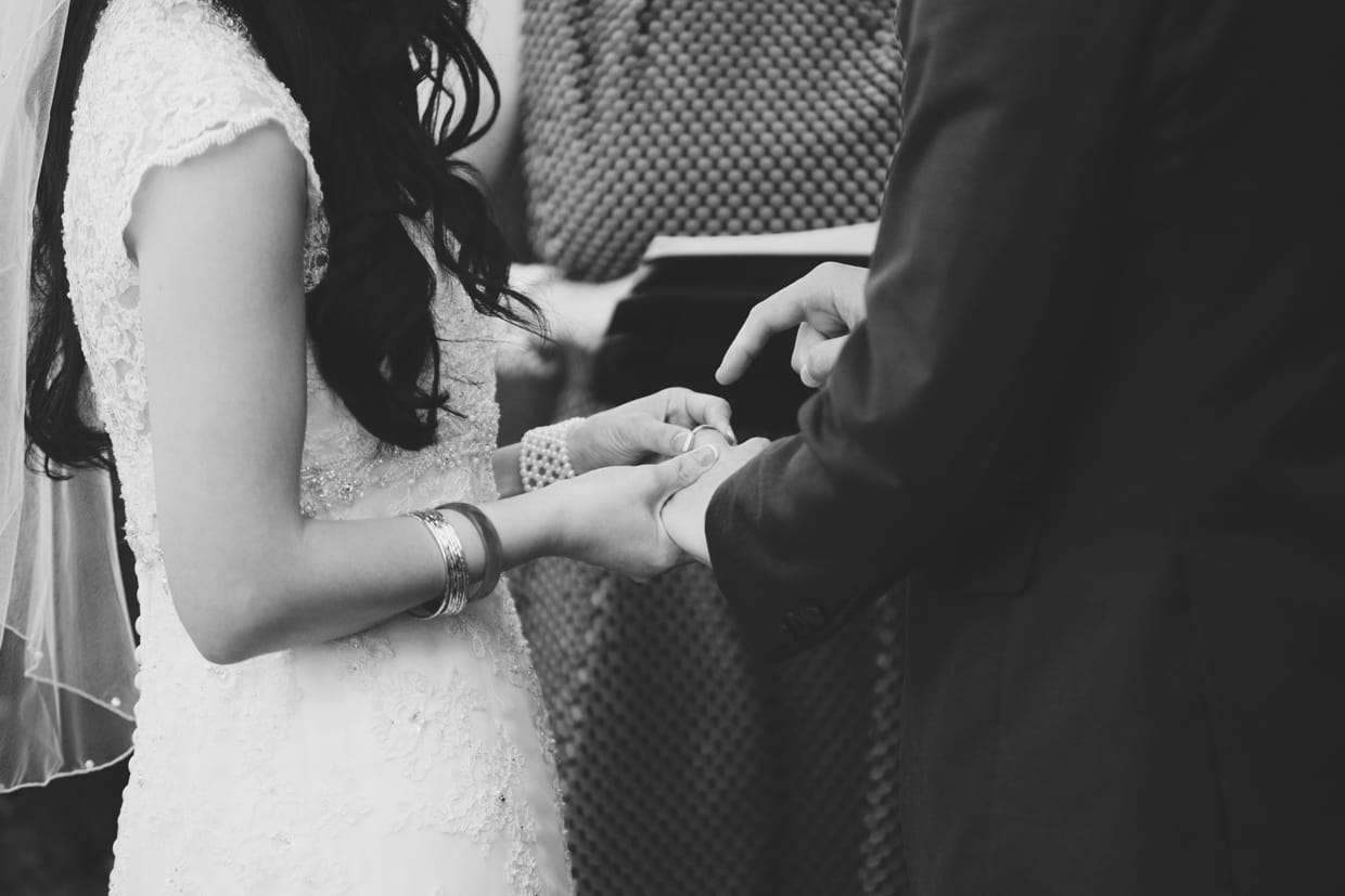 A funny photograph of the groom pointing to the ring during a wedding ceremony at the Boston Marriott Hotel