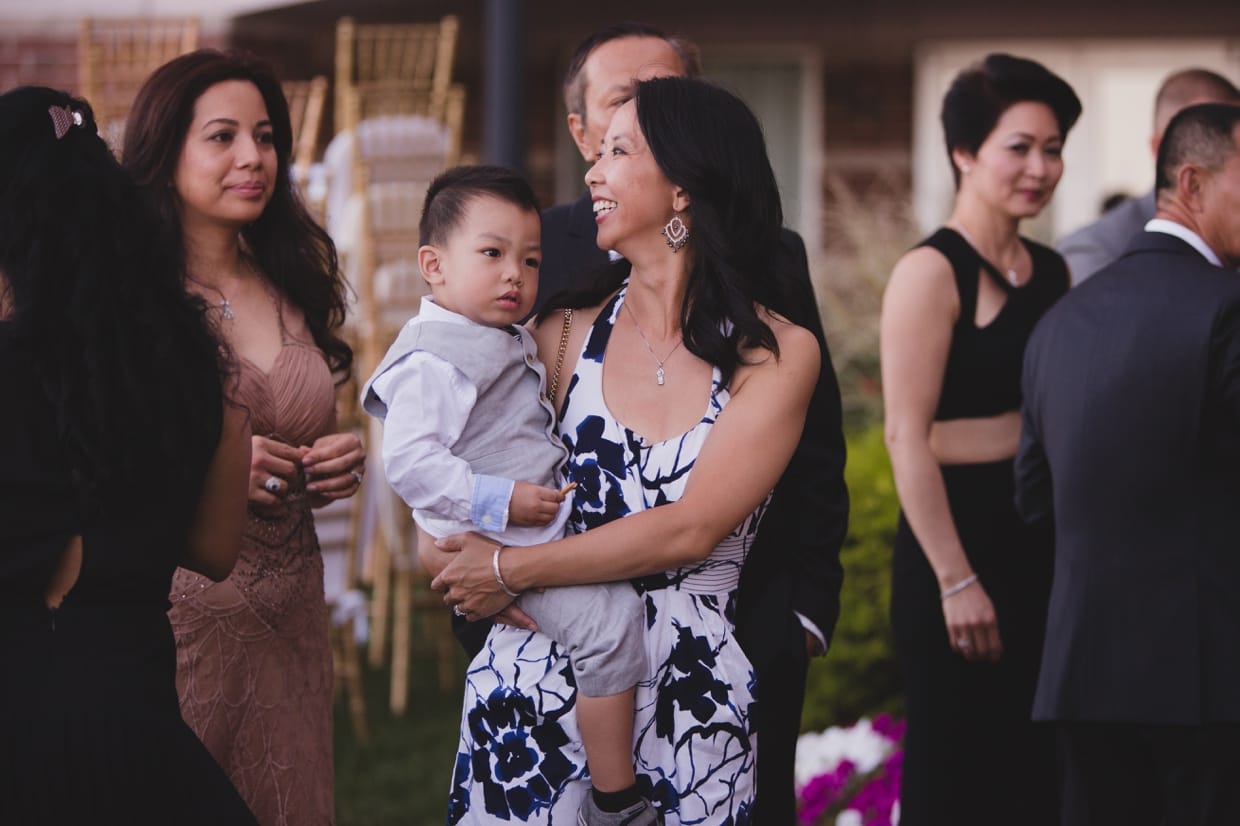 A candid photograph of a mom holding her son during a wedding at the Boston Marriott Hotel