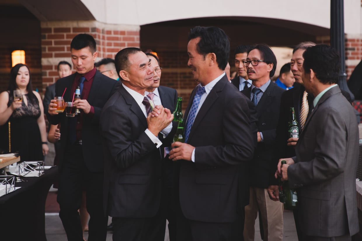 A candid photograph of the father of bride being congratulated at a Boston Marriott Hotel Wedding