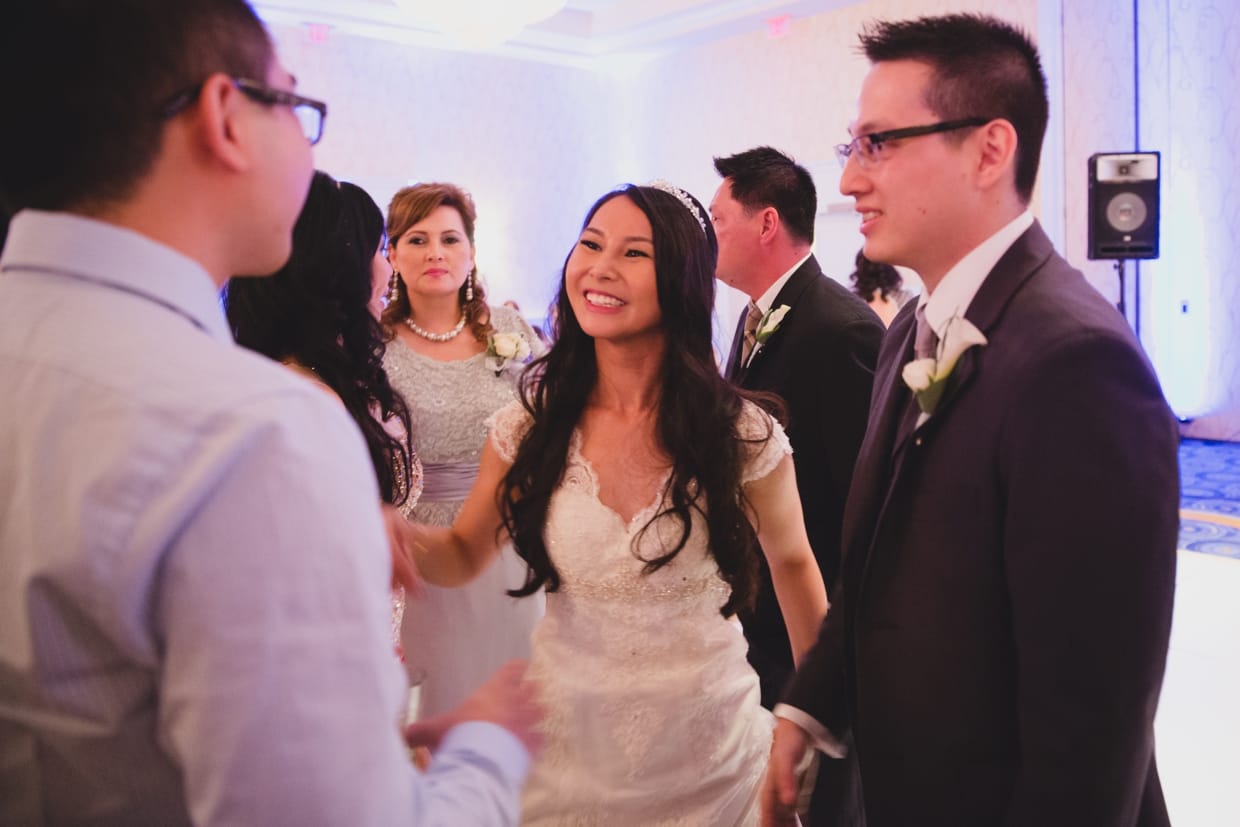 A photograph of a bride laughing with friends during her wedding at the Boston Marriott Hotel