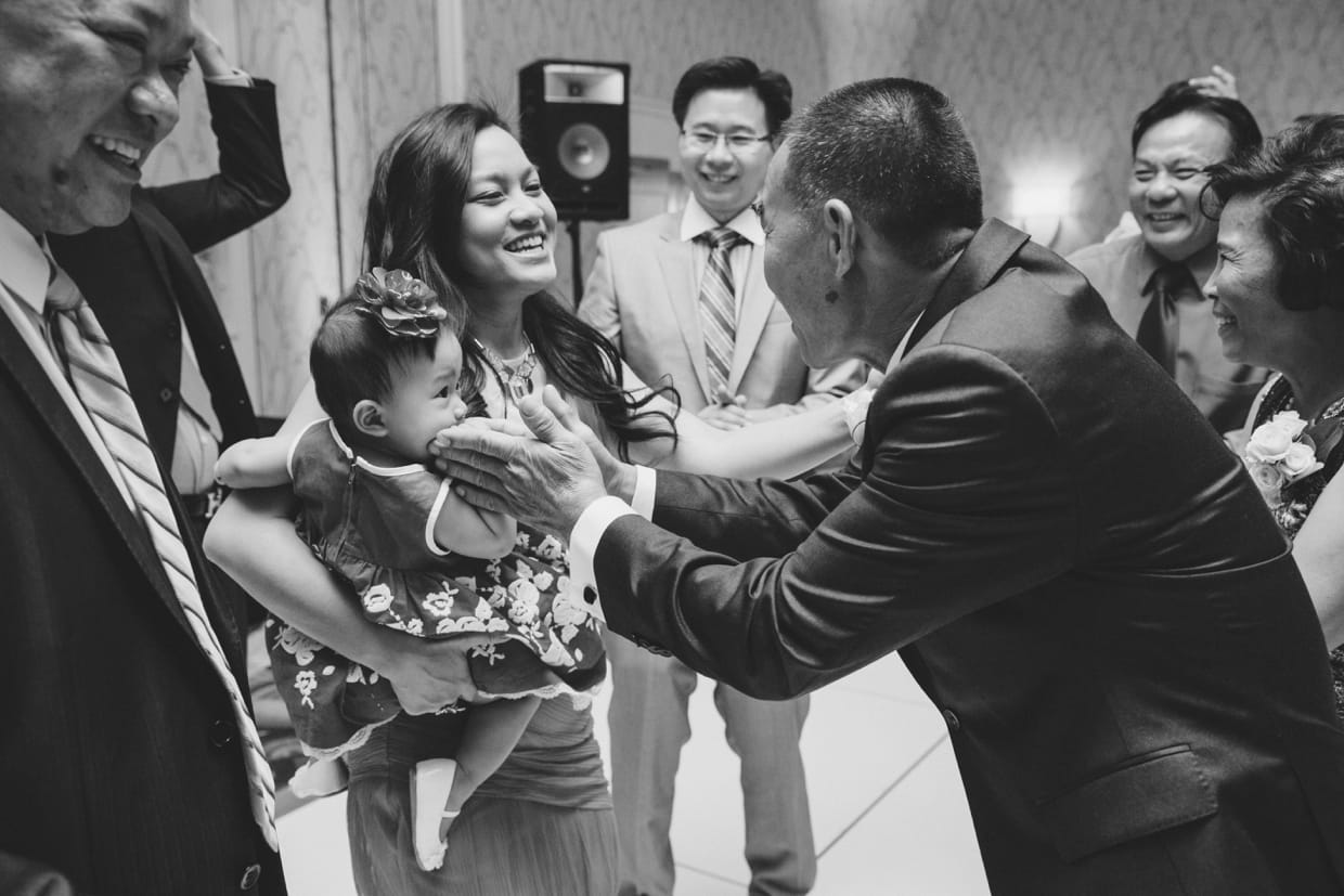 A sweet photograph of guest dancing with a baby during a wedding at the Boston Marriott Hotel