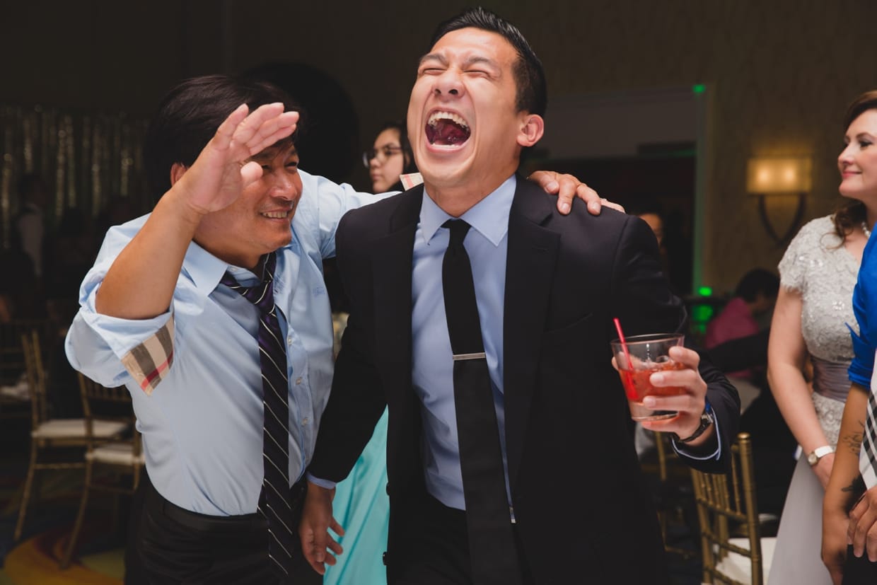 A candid photograph of guests laughing during a wedding at the Boston Marriott Hotel