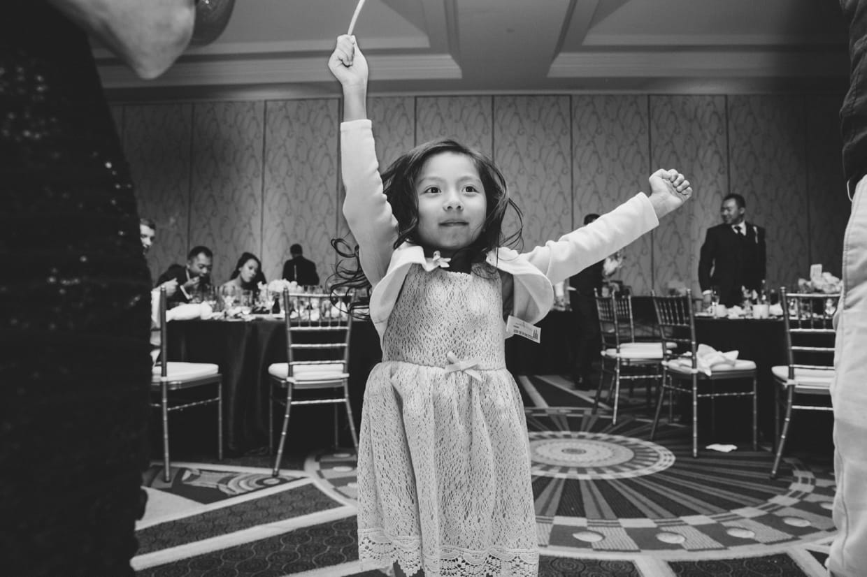 A sweet and fun photograph of a little girl dancing during a wedding at the Boston Marriott Hotel