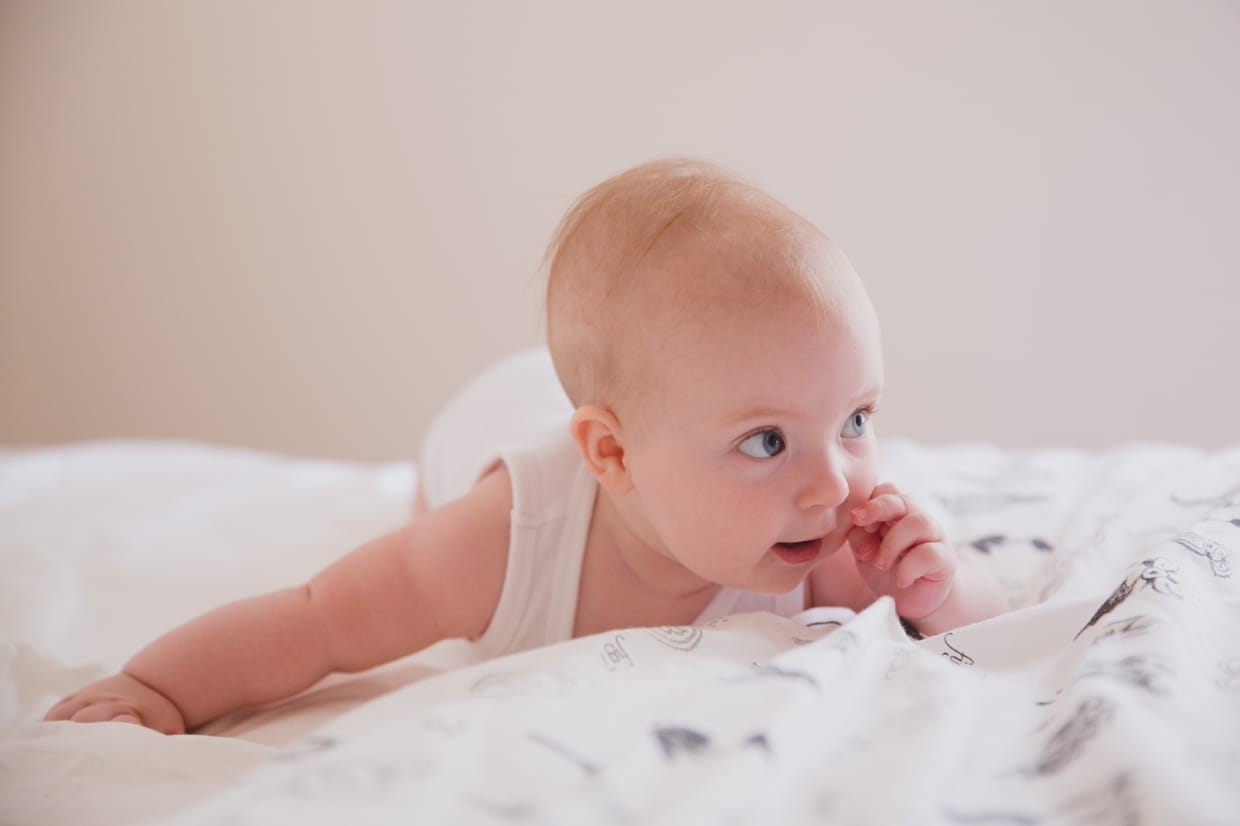 A sweet an natural portrait of a baby girl during an in home family photo session in Boston