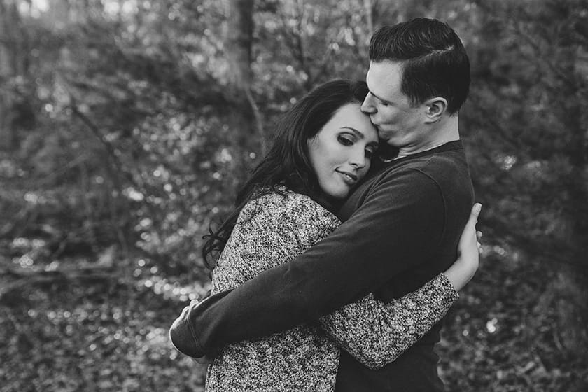 A sweet portrait of a couple hugging during their fall engagement session at Borderland State Park in Massachusetts
