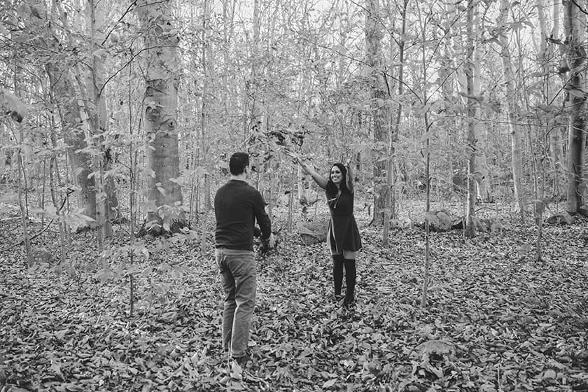 A fun portrait of a couple playing in the fall foliage during their engagement session at the Borderland State Park