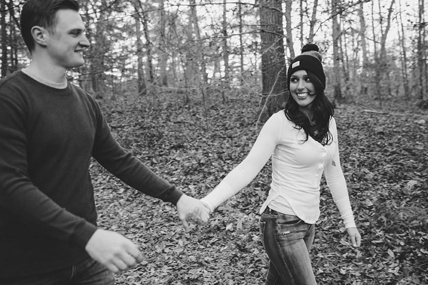 A documentary style portrait of a couple walking through Boderland State Park during their engagement session