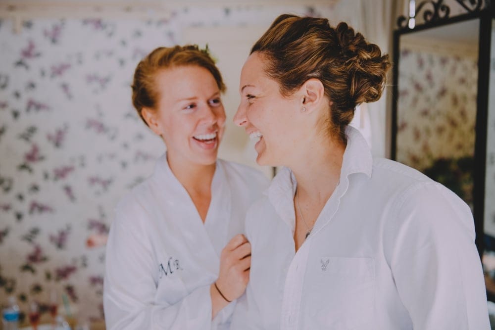 A documentary photogrpah of two brides getting ready at the Governors Inn before their rustic barn wedding at Kitz Farm in New Hampshire