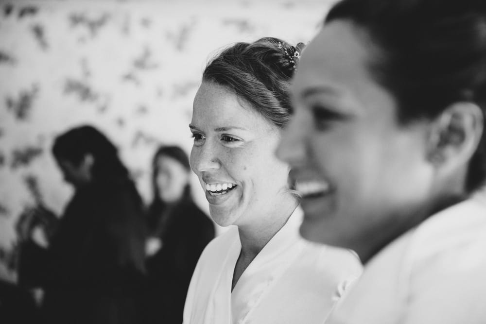 A photojournalistic photograph of two brides getting ready at the Governors Inn before their rustic DIY barn wedding at Kitz Farm in New Hampshire