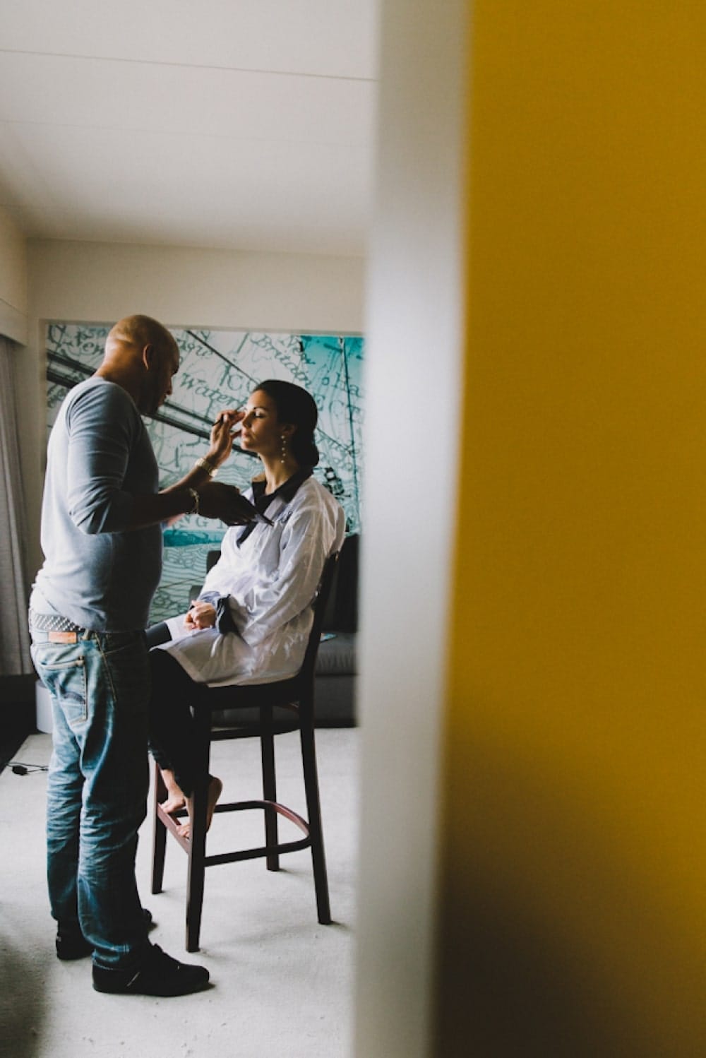 A documentary photograph of a bride getting her makeup done at the Hyatt Regency Hotel before her wedding in Newport, Rhode Island