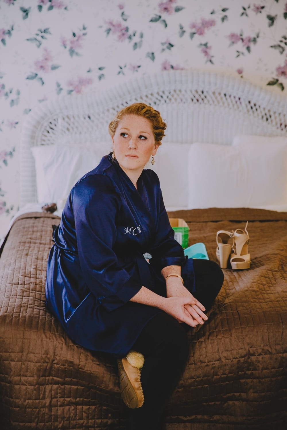 A documentary photograph of a bridesmaid hanging out at the Governors Inn before a rustic barn wedding at Kitz Farm in New Hampshire