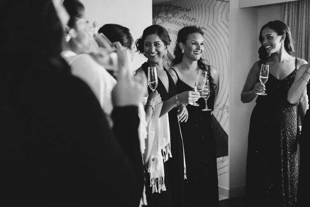 A documentary photograph of bridesmaids sharing a glass a champagne at the Hyatt Regency Hotel in Newport, Rhode Island