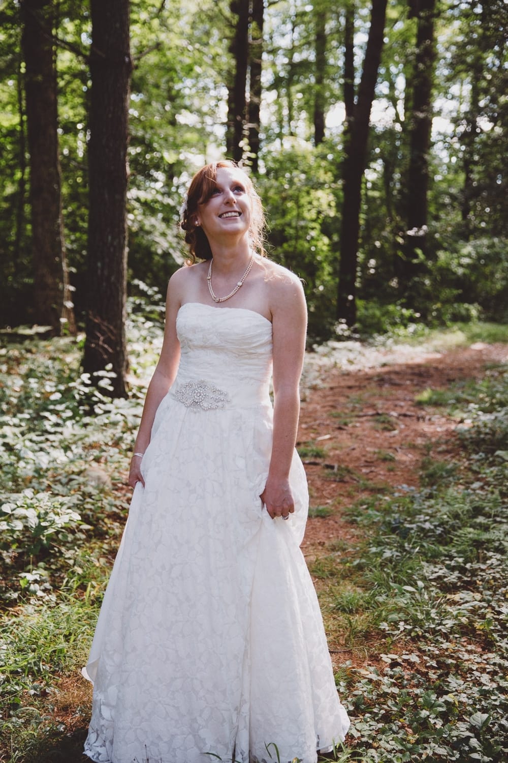 A natural and relaxed portrait of a bride in the woods during her rustic River Club Wedding in Scituate, Massachusetts