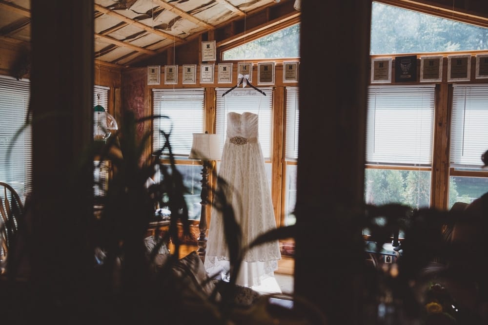 A documentary photograph of a wedding dress before a rustic wedding the River Club in Massachusetts 