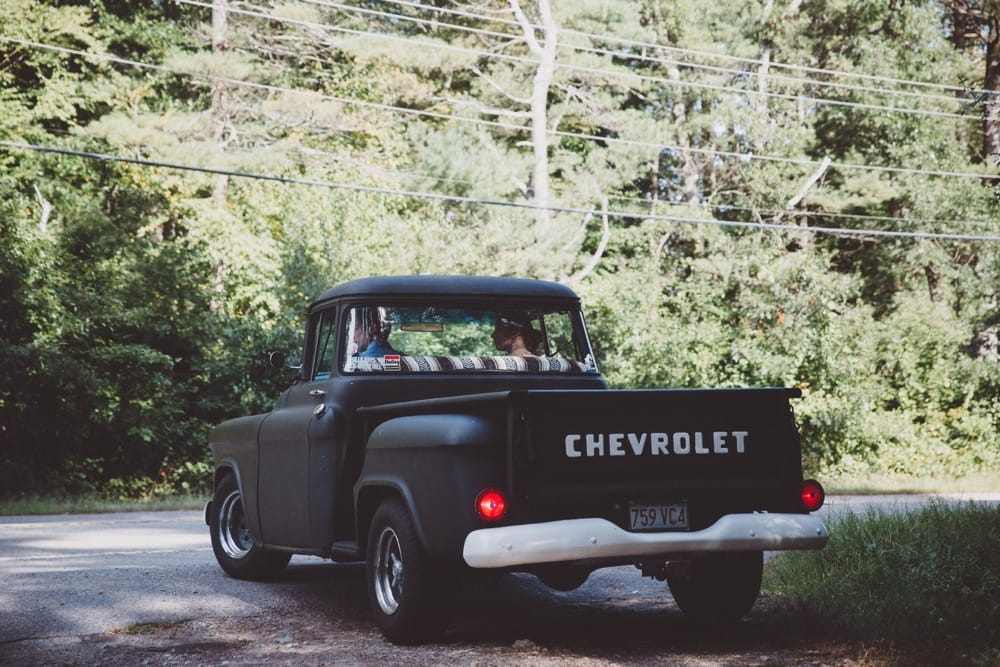 A documentary photograph of a bride going to her rustic River Club Wedding in her vintage Chevrolet truck