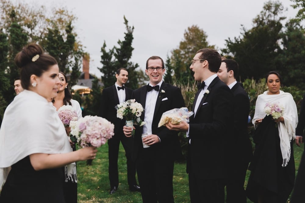 A documentary photograph of wedding guests enjoying cocktail hour at the Castle Hill Inn in Newport, Rhode Island