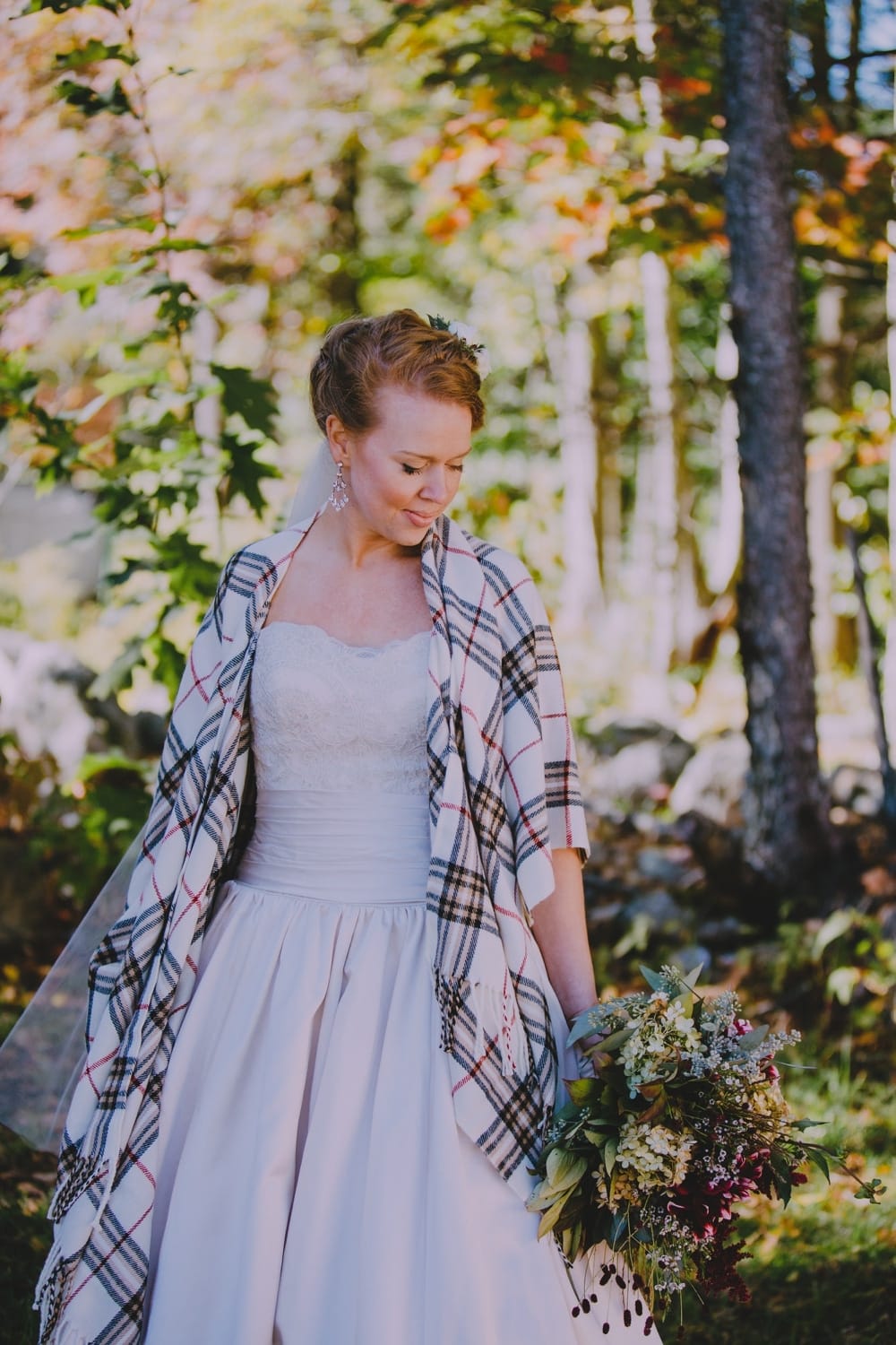 An artistic and natural portrait of a bride during her fall wedding at the rustic Kitz Farm in New Hampshire