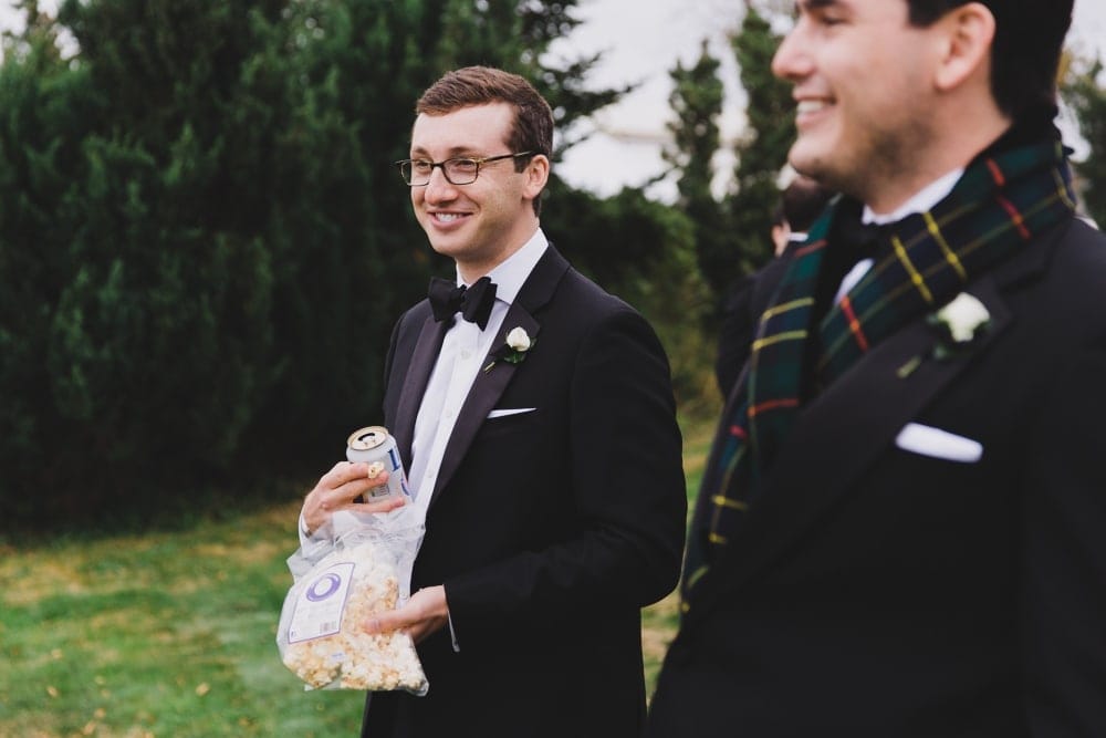 A candid photograph of wedding guests talking and laughing during cocktail hour at the Castle Hill Inn in Newport, Rhode Island