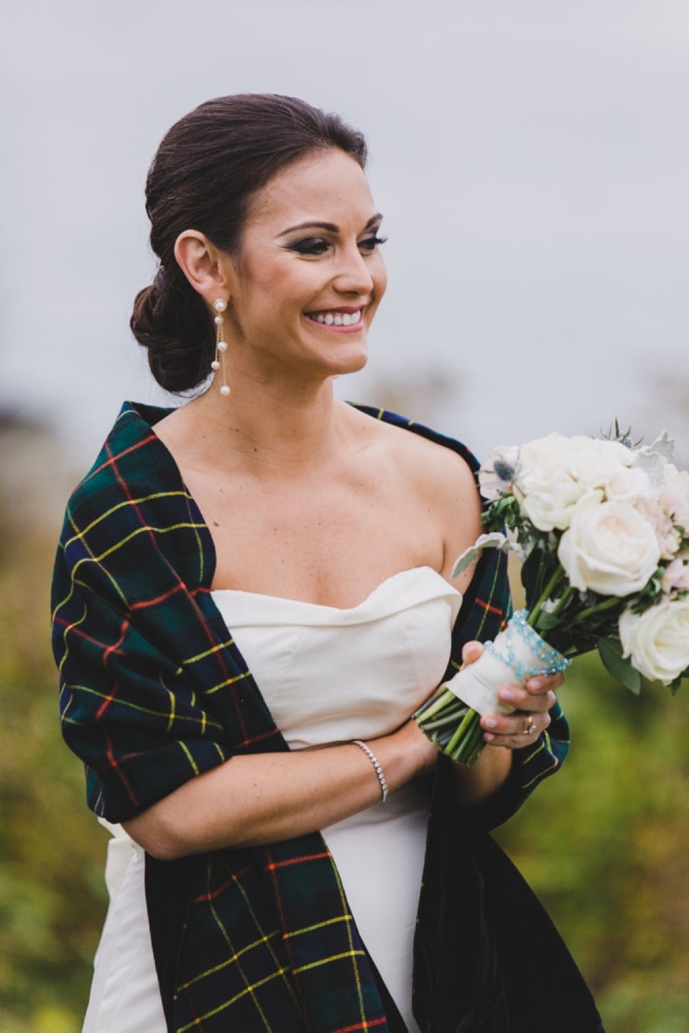 A candid portrait of a bride laughing during her wedding reception at the Castle Hill Inn in Newport, Rhode Island