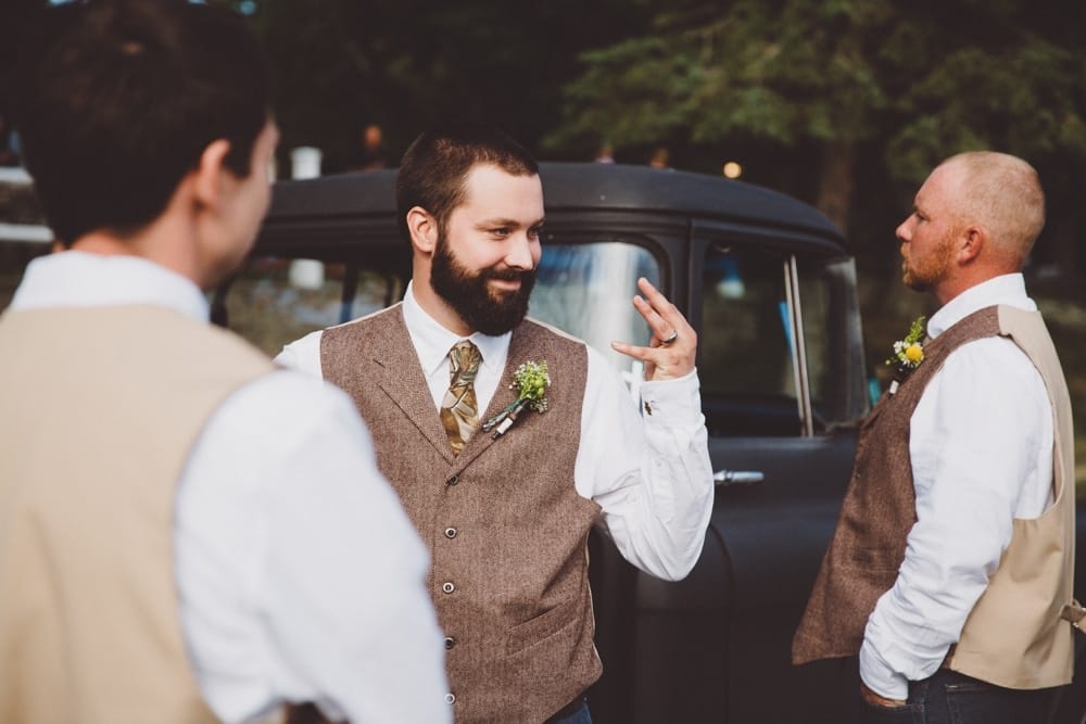 A documentary photograph of groom showing off his wedding ring during a rustic River Club Wedding in Scituate, Massachusetts